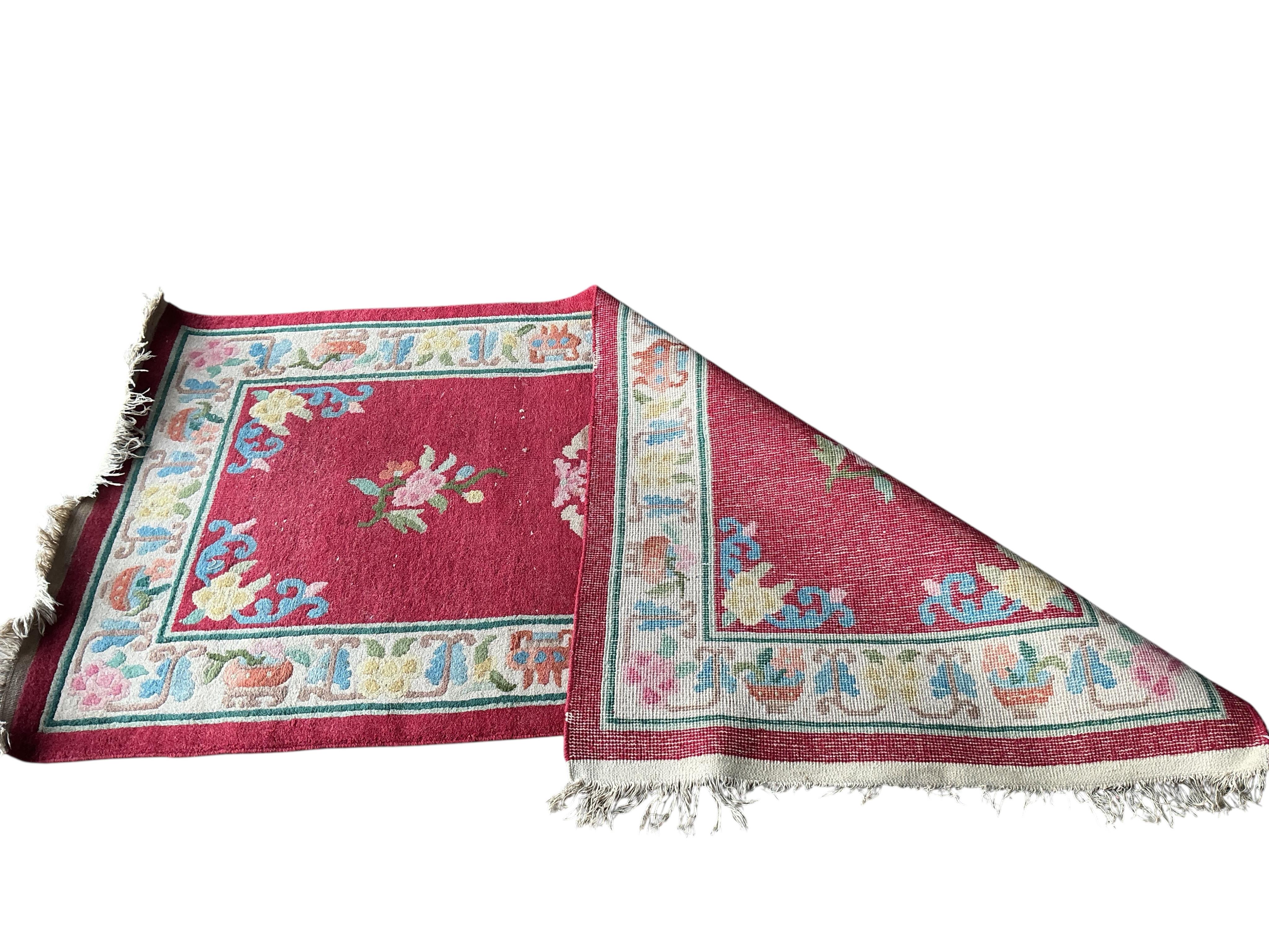 A Chinese red ground rug, 182 x 93cm